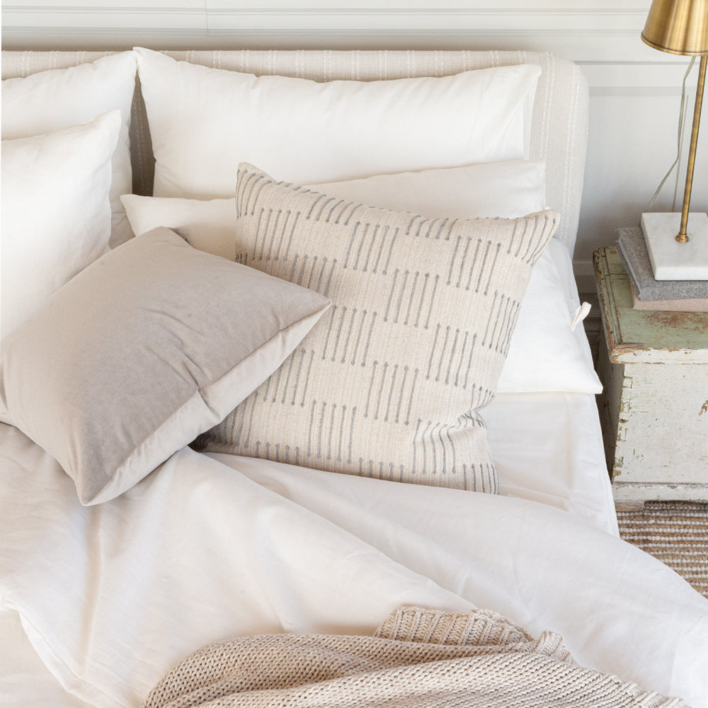 Harlow desert sand and mason velvet mushroom pillow on a bed