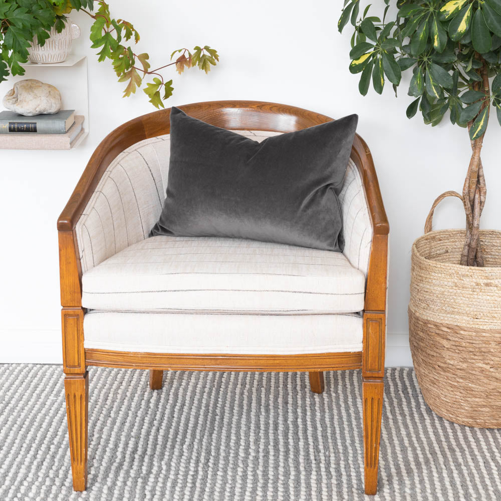 Mason Velvet Shale deep grey velvet lumbar pillow on a stripe vintage chair