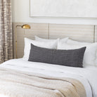 Bed vignette: Misto stripe charcoal 16x42 bolster, Lena Natural throw on bed