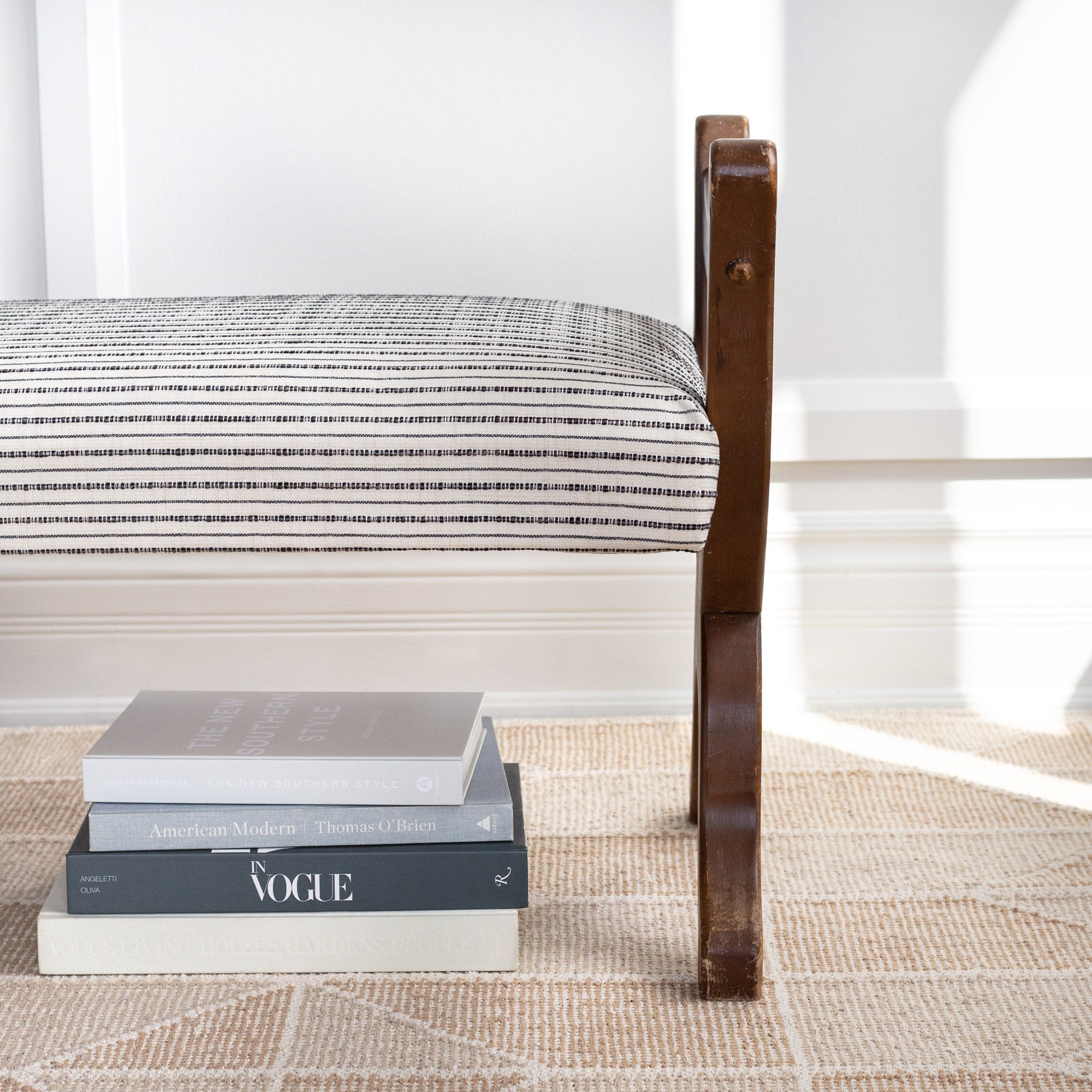 Misto stripe cream and black performance fabric shown on a bench cushion