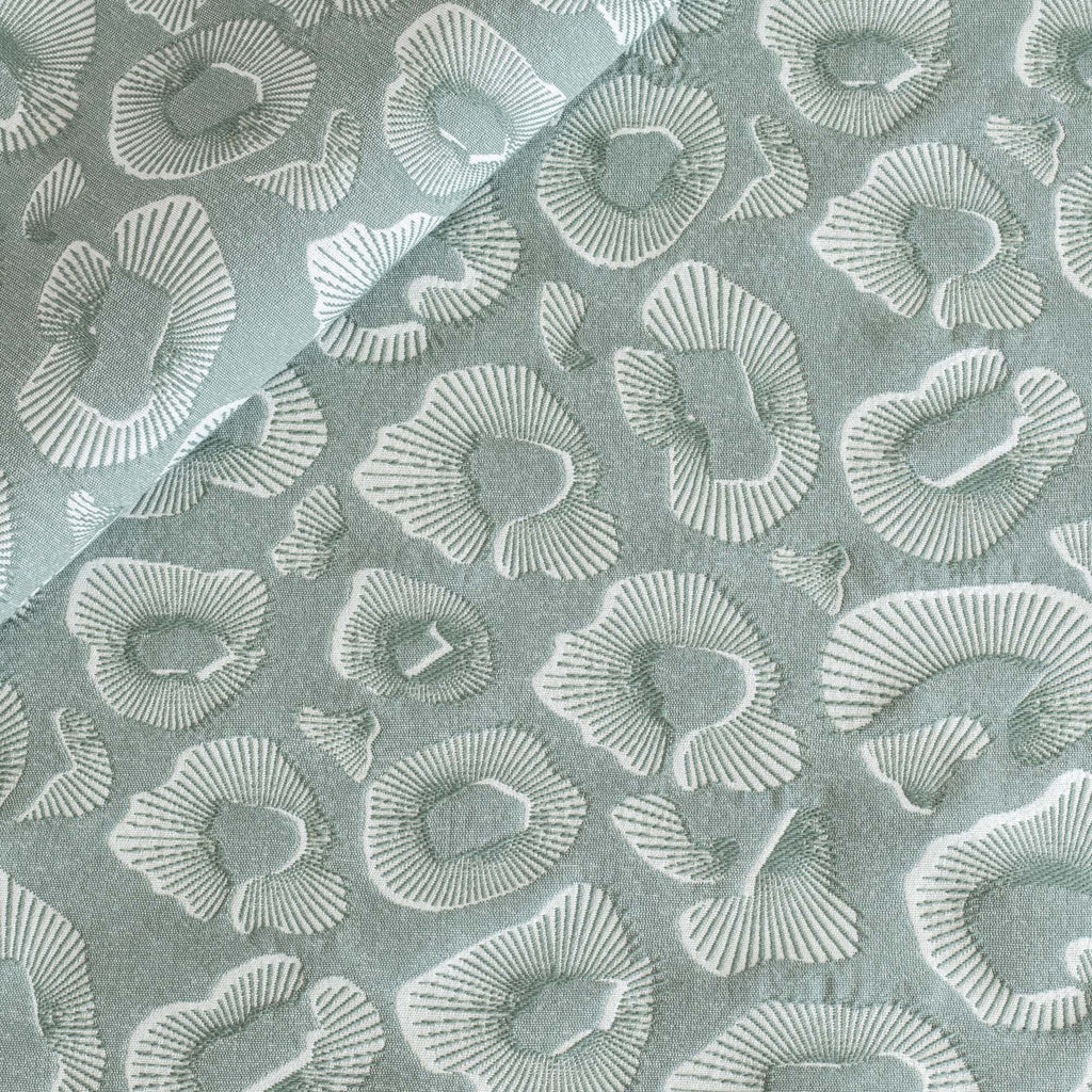 a blue green and white abstract ocean pattern home decor fabric