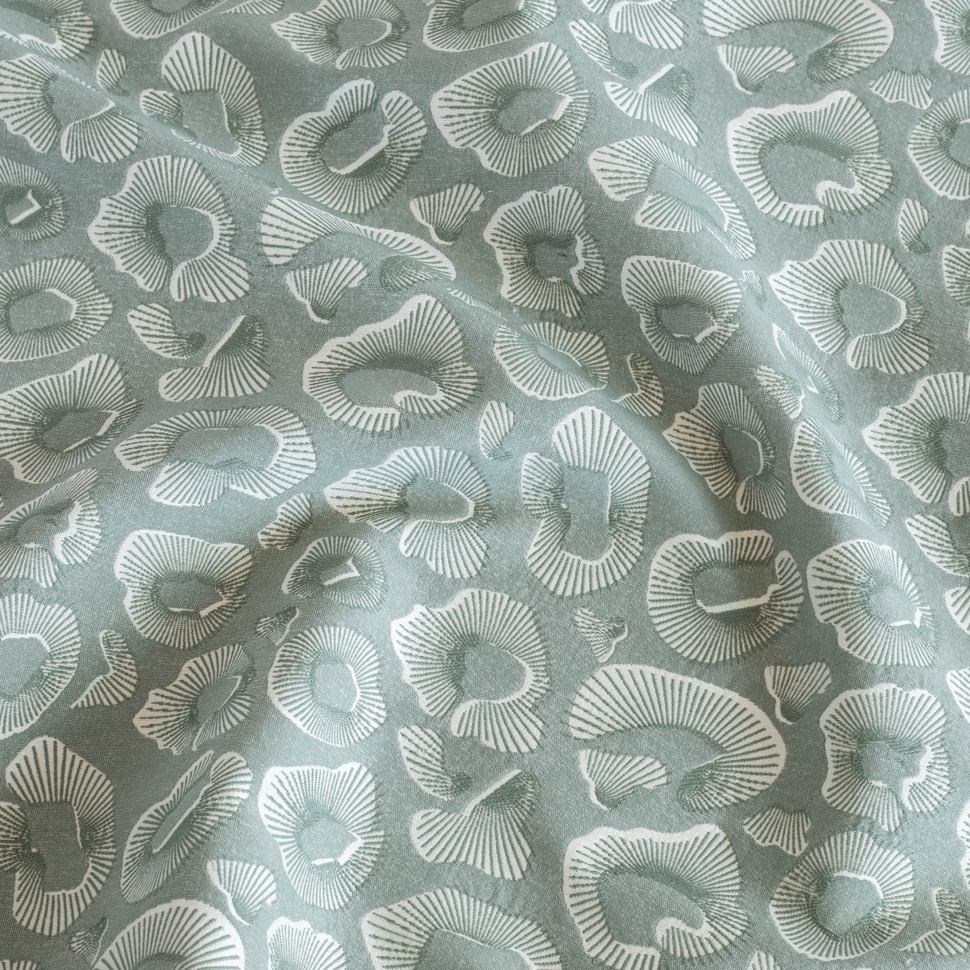 Ocean Jade, a blue green and white abstract ocean motif pattern fabric from Tonic Living