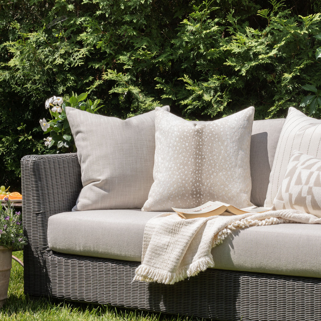 Outdoor decor vignette: Ryder Swell beige pillow with neutral global pattern pillows from Tonic Living