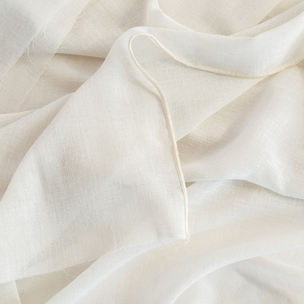 an oyster white sheer curtain fabric with a weighted selvage edge