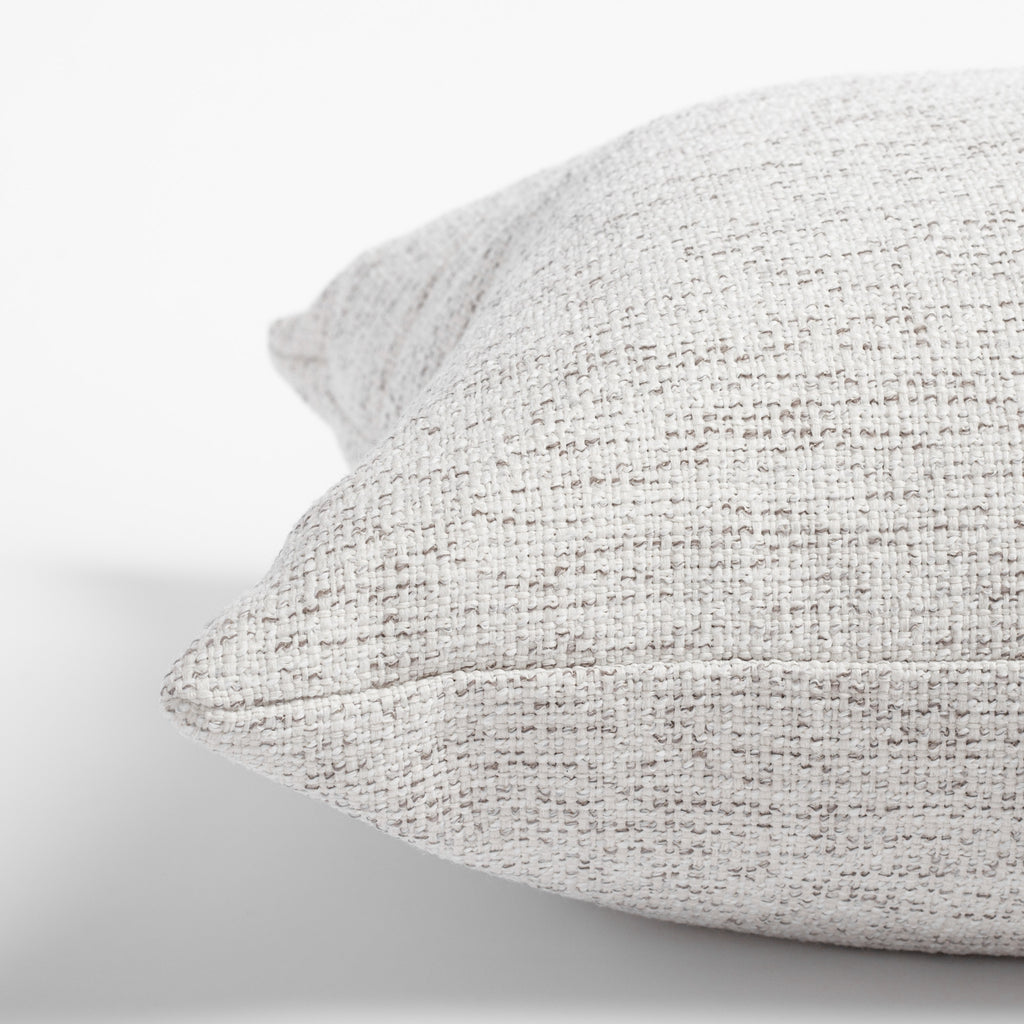 Preston Birch, a heathered cream and light grey indoor outdoor pillow: close up view