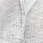 Close up view: a light cream indoor outdoor upholstery fabric, with strands of warm grey