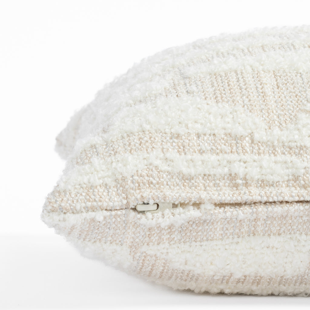  a cream textured abstract patterned lumbar throw pillow : close up zipper view