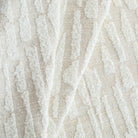 a cream, abstract patterned, boucle textured Tonic Living upholstery fabric