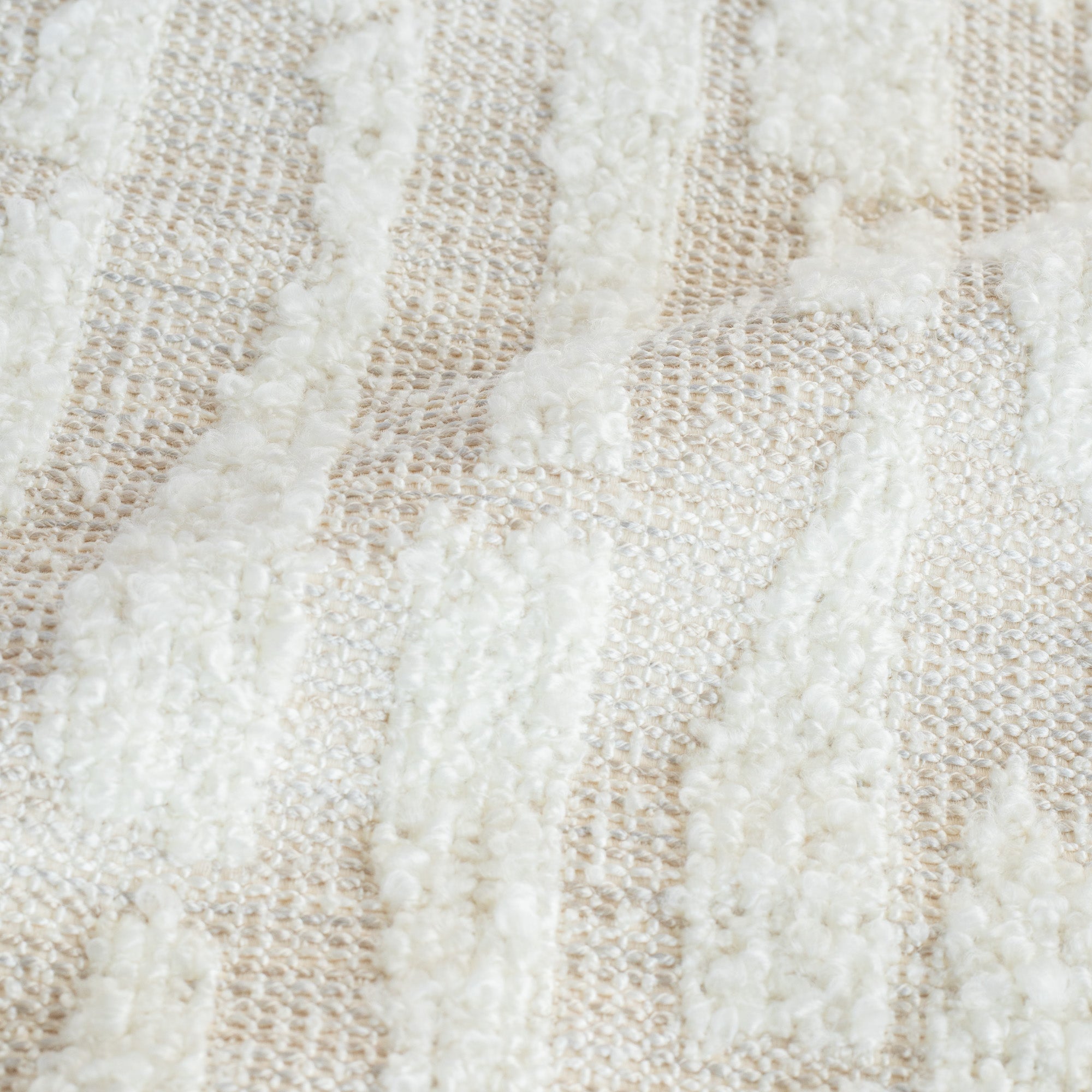 a cream, boucle textured upholstery fabric