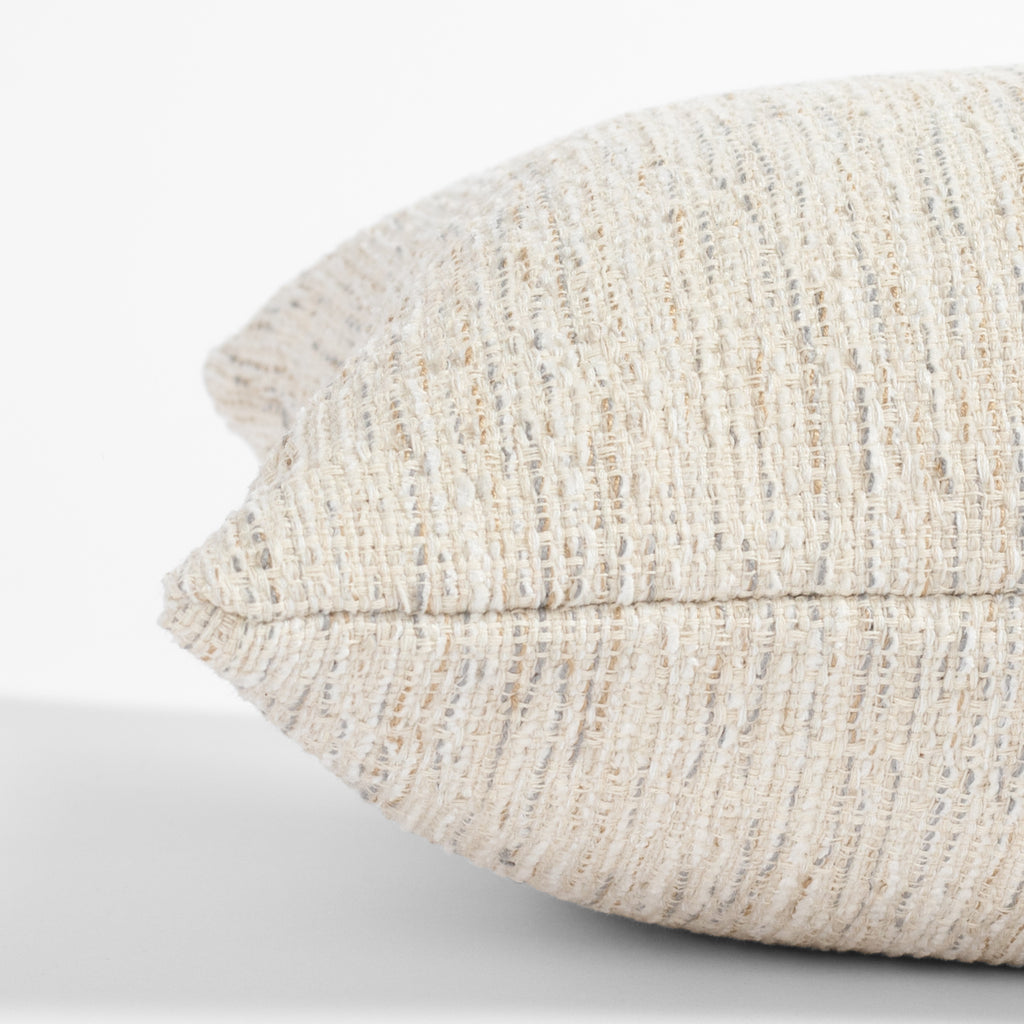 a cream lumbar throw pillow : side detail