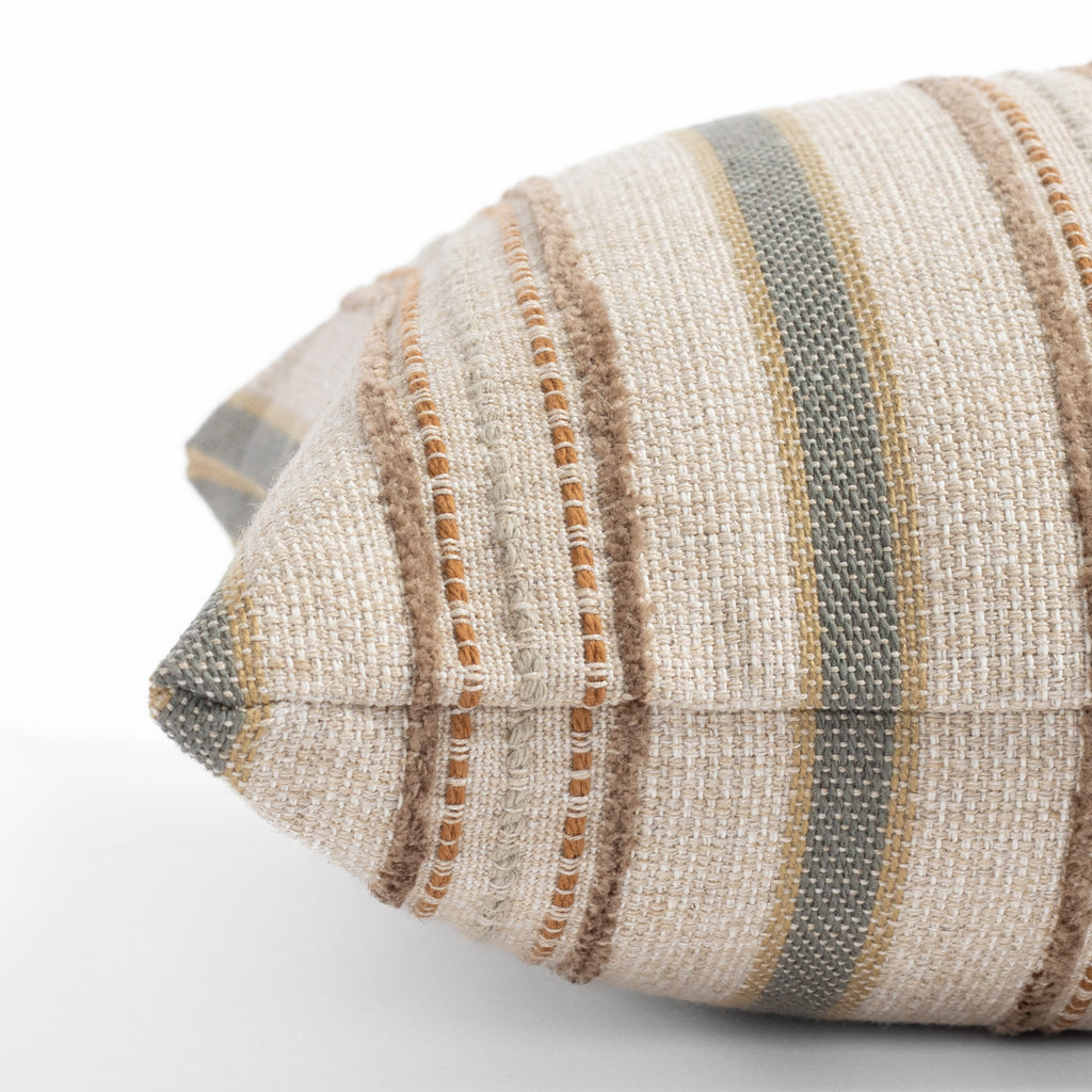 an oatmeal beige, grey and terracotta earth toned vertical multi striped lumbar pillow : close up side view