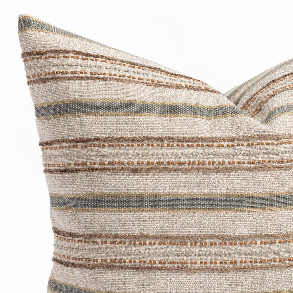 an earth toned multi-striped throw pillow : close up view