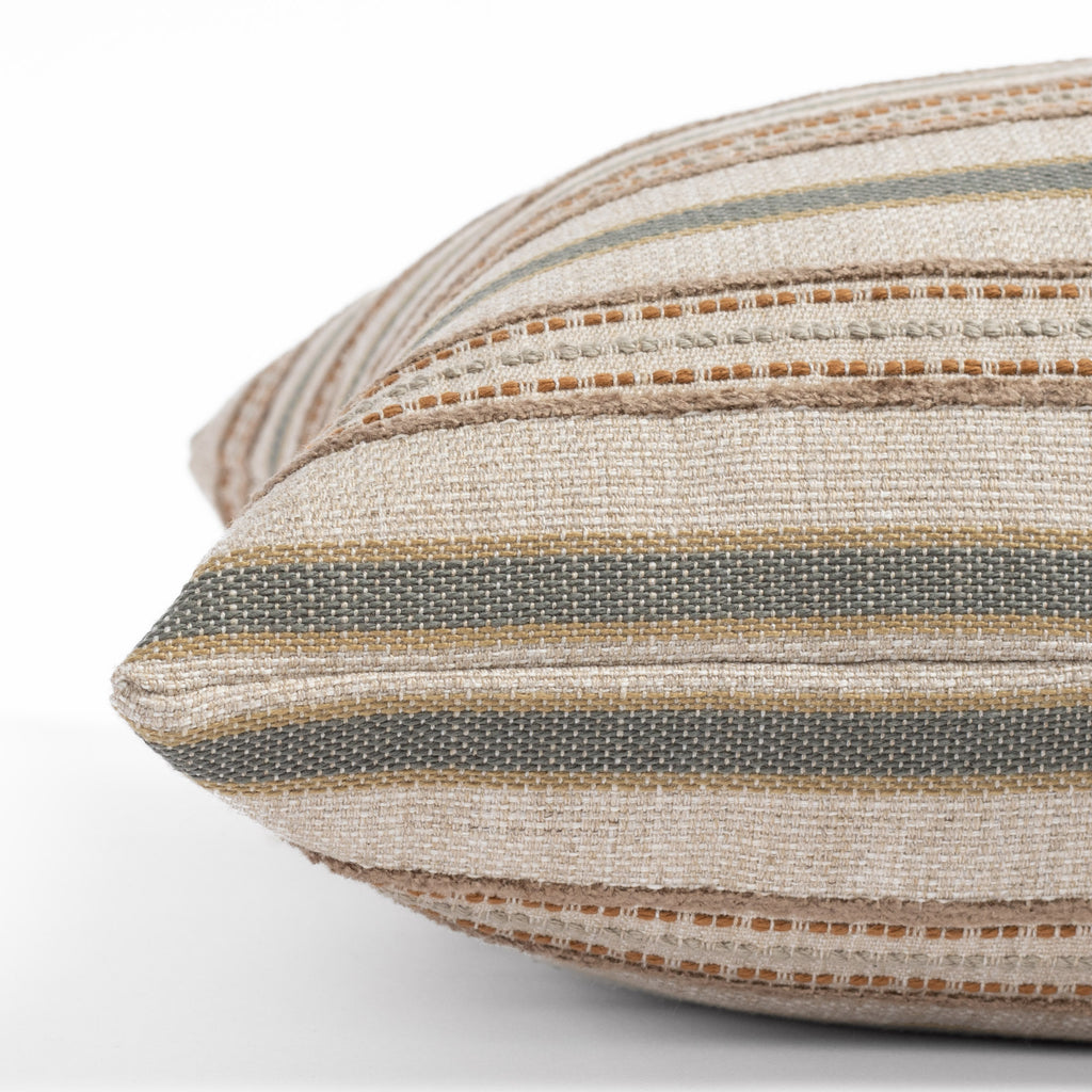 an earth toned multi-striped throw pillow : close up side view