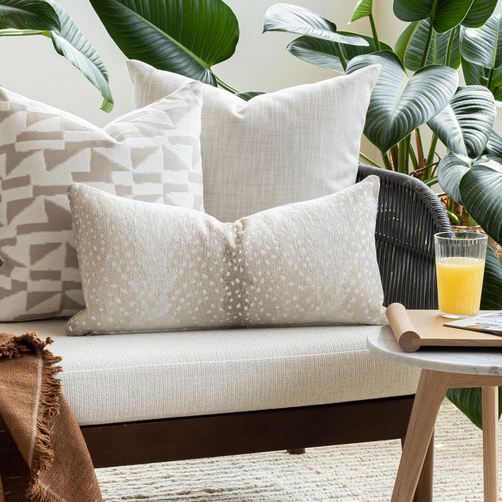 Indoor Outdoor decor vignette: Ryder Swell beige pillow with neutral global pattern pillows from Tonic Living