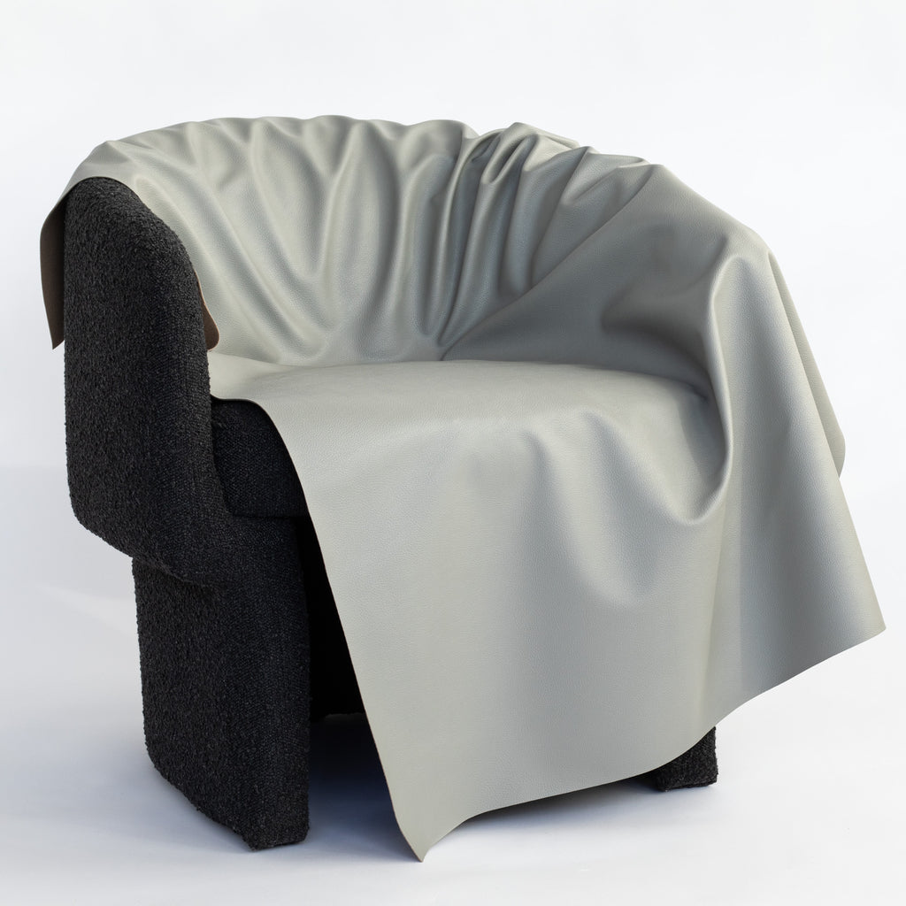 a grey vinyl upholstery fabric draped on a chair