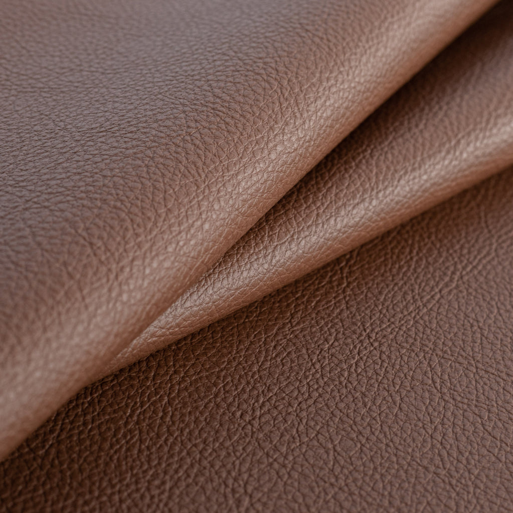 a deep brown vinyl faux leather performance upholstery fabric : close up view