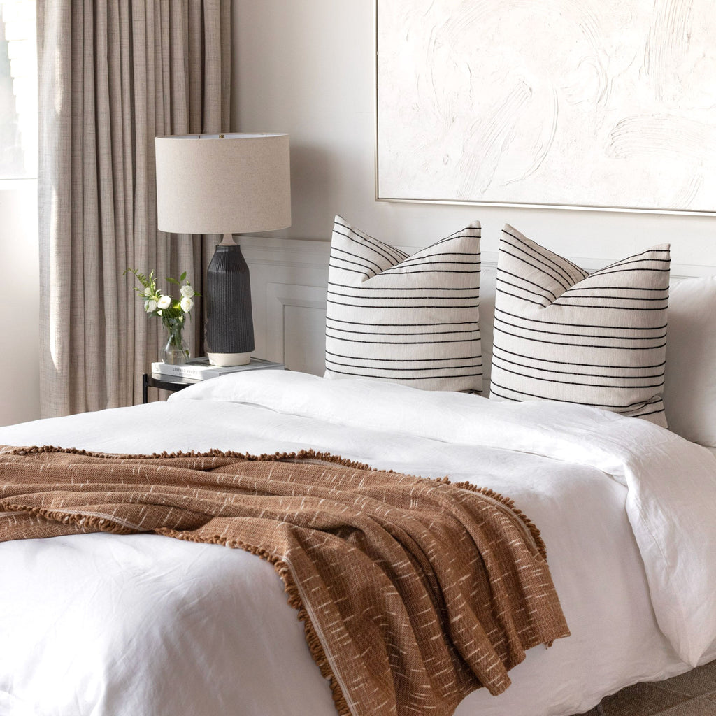 Bed Vignette : two Spar Stripe cream and black pillows with Rafael Cork blanket