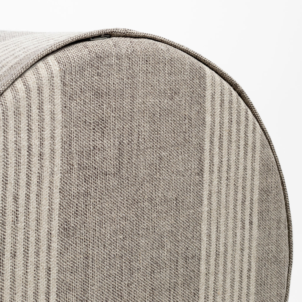 a natural tan and faded black striped linen round ottoman : bottom view