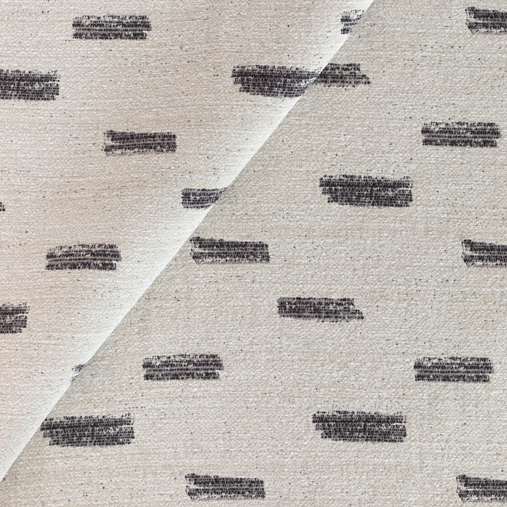 Stratus Fabric Cream, a cream upholstery fabric with an abstract black brush stroke pattern from Tonic Living