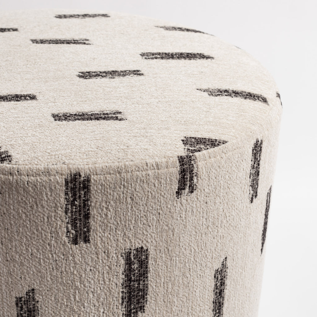Stratus 18x16 Round Ottoman Cream, a cream with painterly black stroke patterned fabric ottoman : close up top view