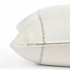 a chunky light blue stripe and cream patchwork pattern bolster pillow : close up zipper detail
