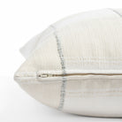 a chunky light blue stripe and white cream patchwork patterned throw pillow : close up zipper view