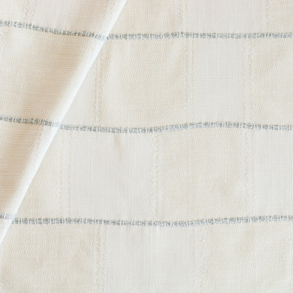 Sutton Cloud Fabric, a cream and off white patchwork pattern with a chunky light blue horizontal stripe fabric from Tonic Living