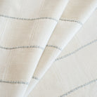 a cream and off white check fabric with a chunky light blue horizontal stripe