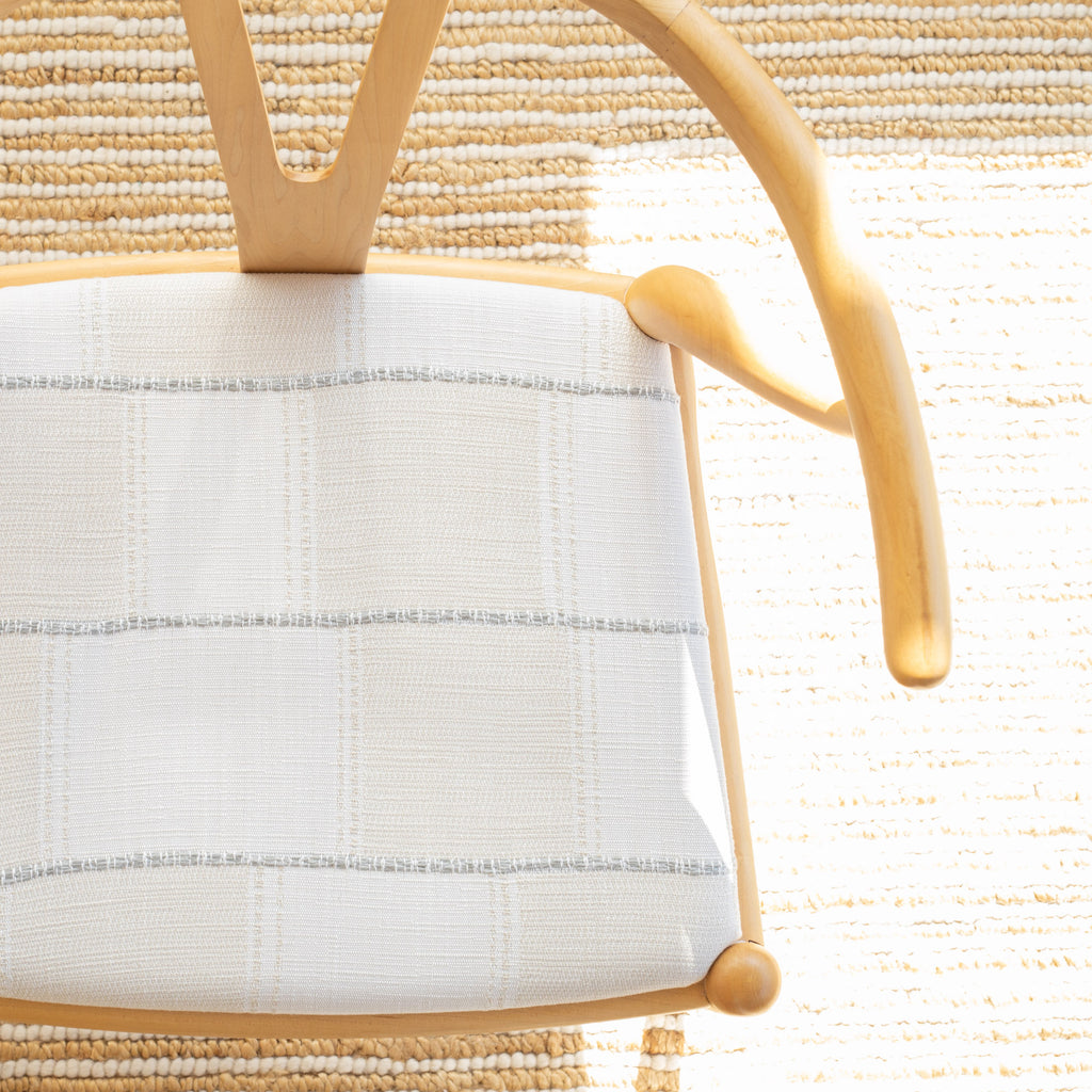 a cream and white patchwork pattern with a a chunky light blue horizontal stripe upholstery fabric dining chair seat