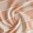 a sand and terracotta patchwork pattern with a chunky beige stitched horizontal stripe home decor fabric