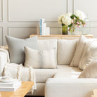 Tonic Living home decor: neutral muted cream and blue-grey toned, modern patterned throw pillows on a cream sectional sofa