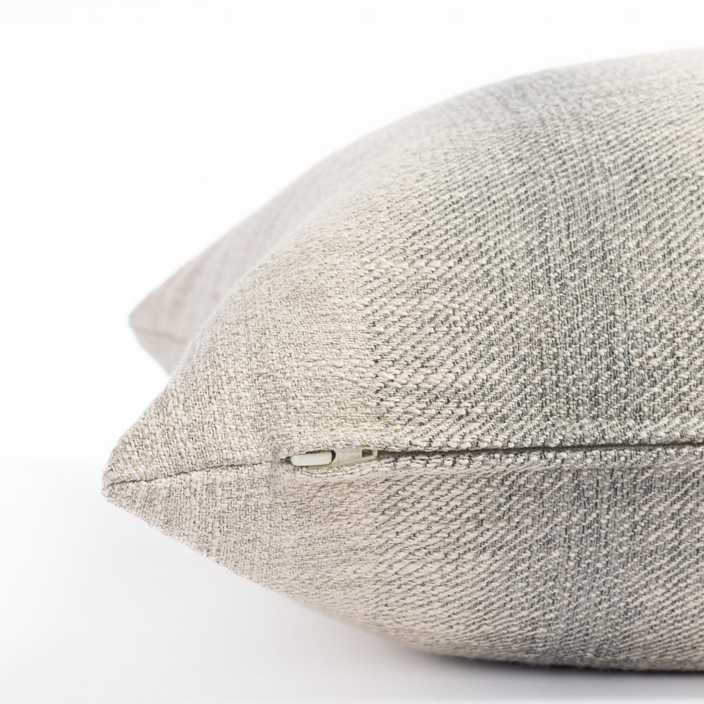 a blue and sandy gray ombré stripe throw pillow : close up zipper view