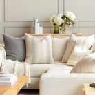 Tonic Living pillow on a cream sectional : modern decorative throw pillows in neutral cream and muted blue greys