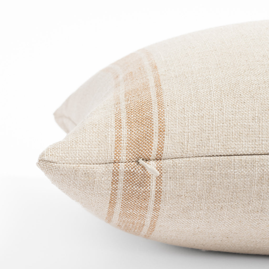 a faded rust and cream wide vertical ticking stripe lumbar pillow : close up zipper view