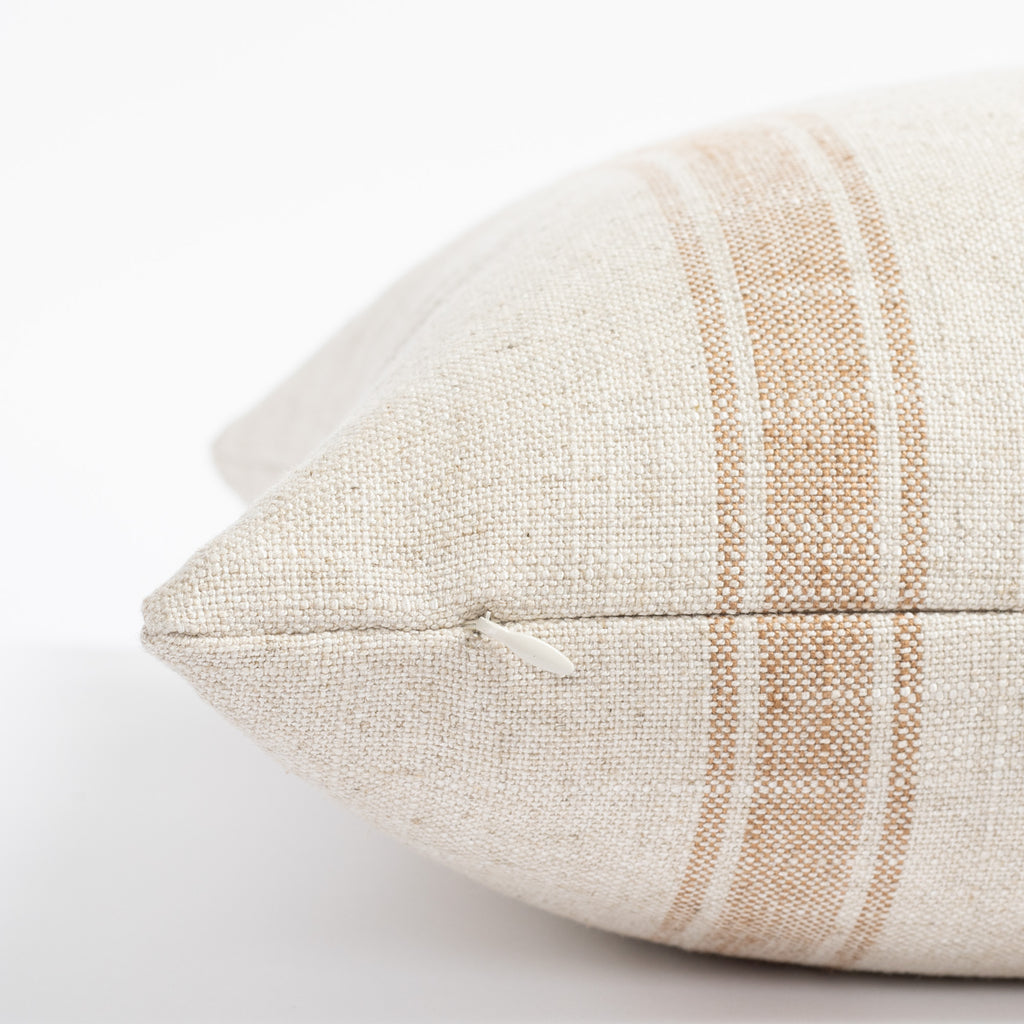 a cream and faded rust stripe throw pillow : close up zipper view