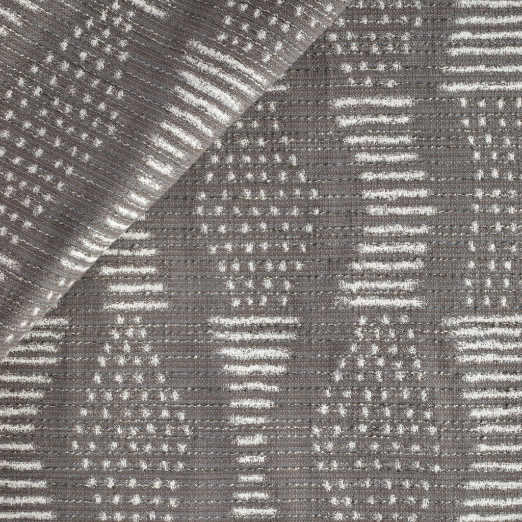 Zipporah Nickel, a dark grey upholstery fabric with cream dot dash motifs from Tonic Living